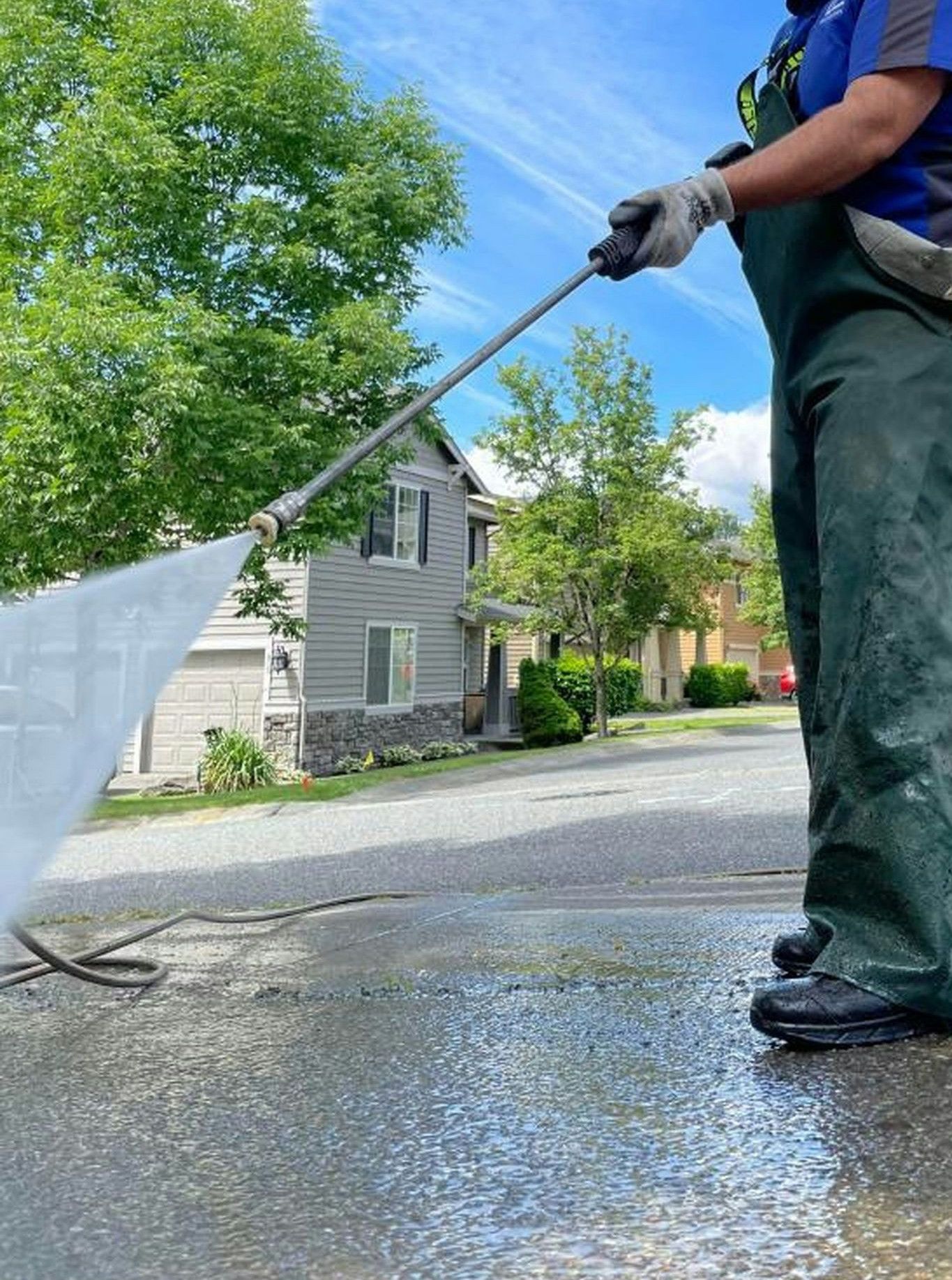 a man is cleaning the street with a hose